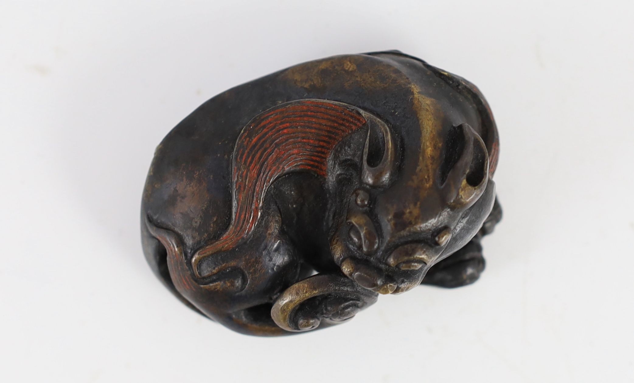 A Chinese bronze ‘lion dog’ scroll weight, Ming or later, 6.4cm long